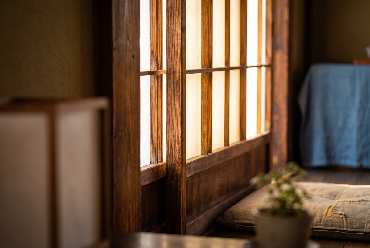 A narrow Tokyo yokocho alley lit by red lanterns and hanging signs at dusk